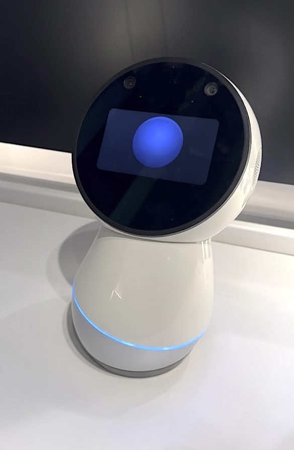 Squat white robot with a circular image in a circular screen